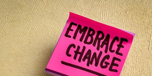 Sticky note spelling 'embrace change'